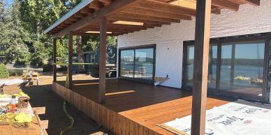 New wooden deck under construction on house porch.