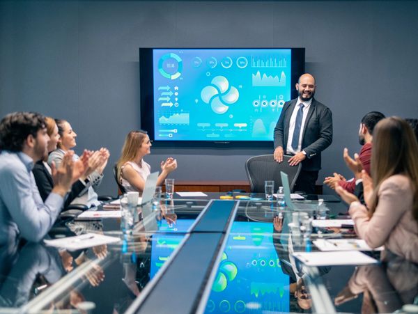 Business team listening to a presenter in a boardroom.