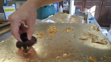Skewing excess gold leaf with kabuki brush