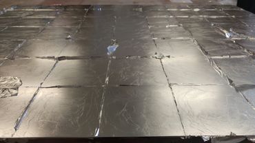 Gilded panel before skewing the excess aluminum leaf