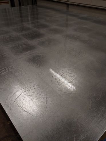 Gilded panel after skewing the excess aluminum leaf and sealing with clear coat