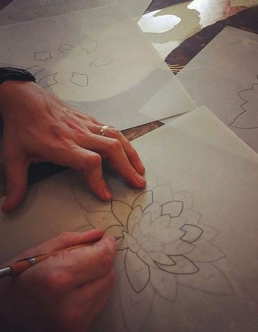 Gilder/Artist creating stencil of lily to be gilded