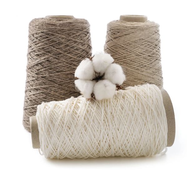 Three spools of thread with a cotton flower.