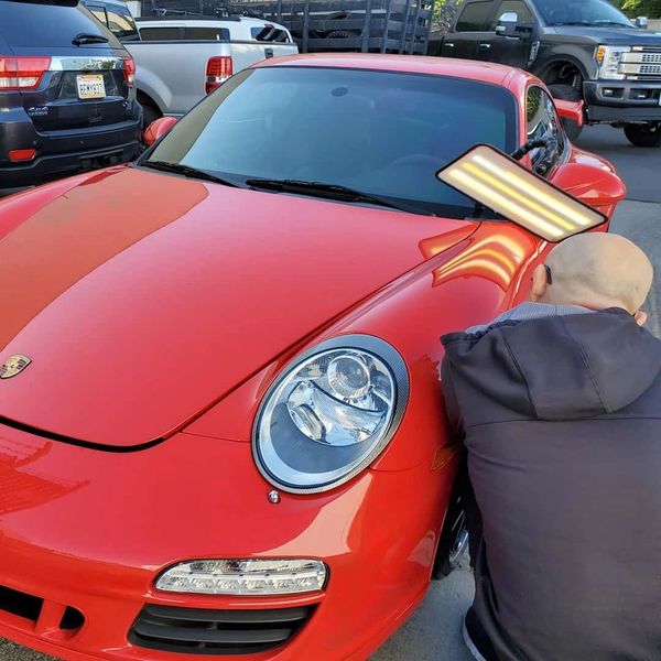 Mobile paintless dent repair on Porsche 911 drive side fender  
In Antelope Ca