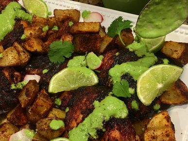 Peruvian Style Chicken with Green Sauce served with roasted potatoes.