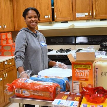 Volunteer in kitchen with food.