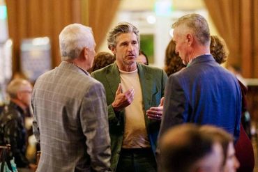 Chris Barron and Shawn Gardner talking with Patrick Dempsey at a Dempsey Center Gala in 2024.