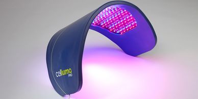 A Celluma Pro LED light therapy device emitting purple and red light.