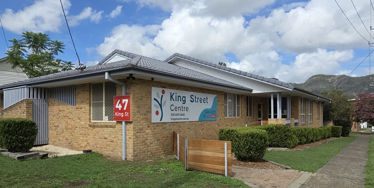 Brick building with King Street Centre sign at 47 King St.