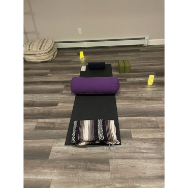 Yoga mat and props set up for yoga therapy session