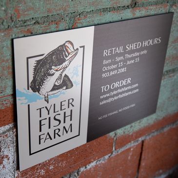 Digitally printed metal sign with a fish and business information