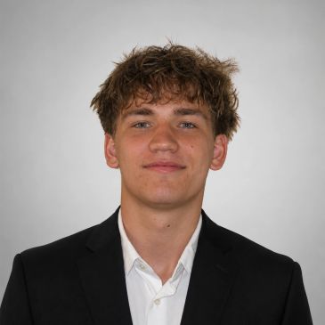 Young man in a suit with a confident expression.