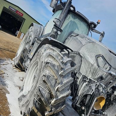 Tractor covered in foam for cleaning.