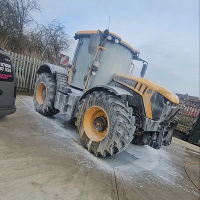 Tractor being washed with foam.