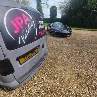 Van with JPA Valeting logo and luxury car on gravel driveway.