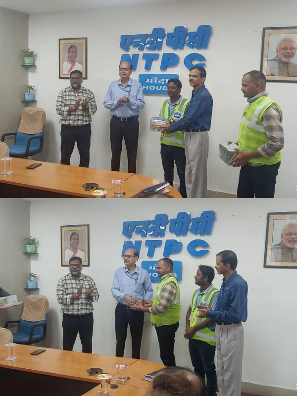 Award ceremony at NTPC Moudi office with five men exchanging gifts and applauding.