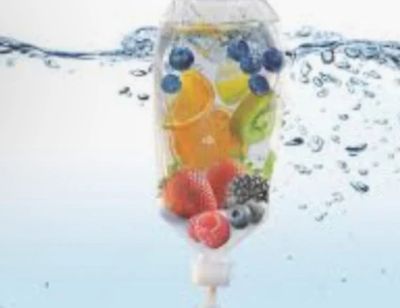 Infusion bag filled with assorted fresh fruits submerged in water.