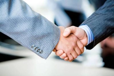 Two business people shaking hands.
