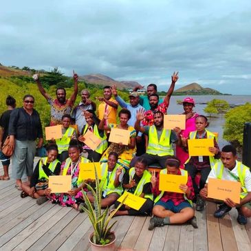 Local youth holding graduation certificates after completing the NCDC and World Bank-funded training at Mangroves Relax Farm.