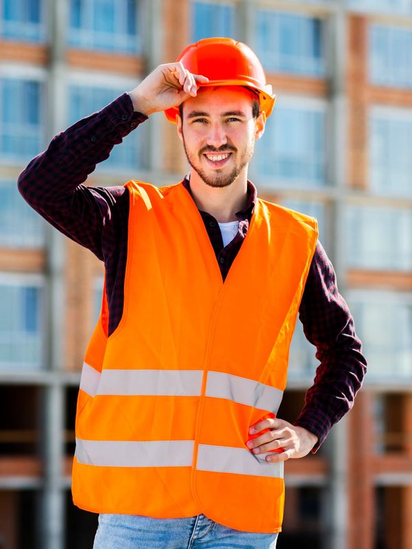 a worker clad in orange reflective safety jackets touch his helmet with hand