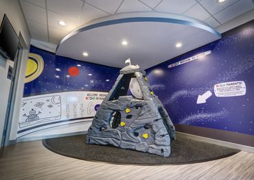Space station play area in KIDS Urgent Care waiting room.