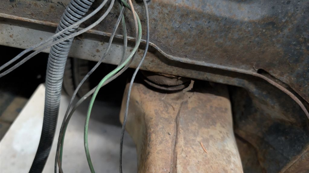 Sandwiched body mount bushing crushed from years of service.