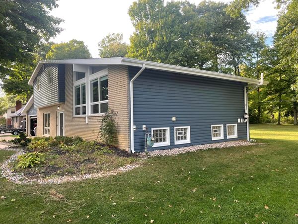 After picture of Thompson & Son's installing deep blue siding for these homeowners.