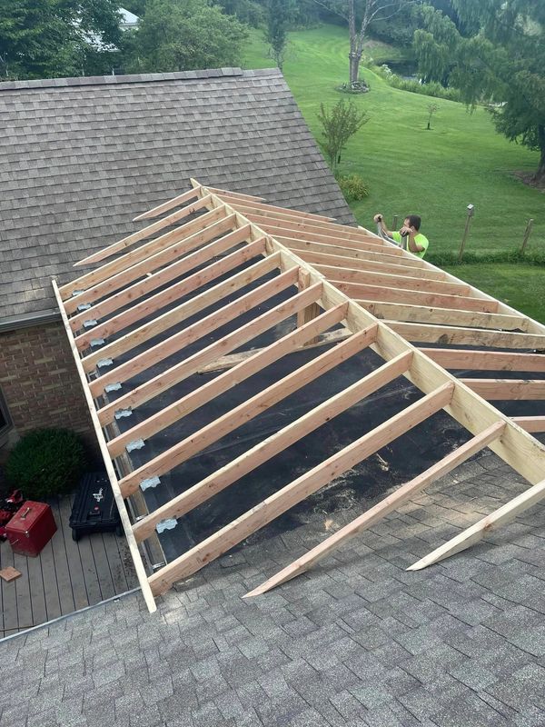 Framing a pitched roof overtop a flat roof so it will stop leaking.