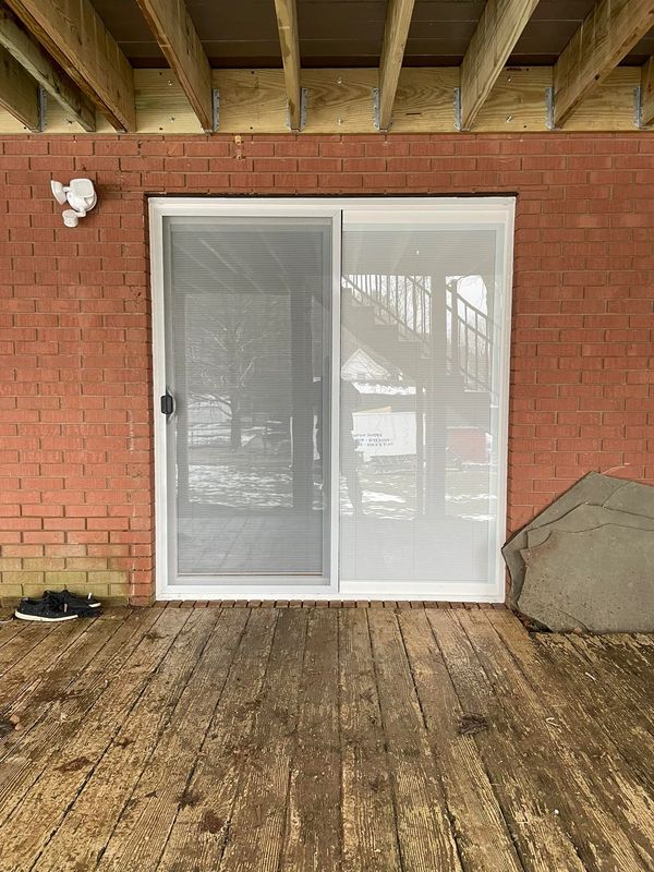 Sliding glass doors with built in blinds installed with handles.