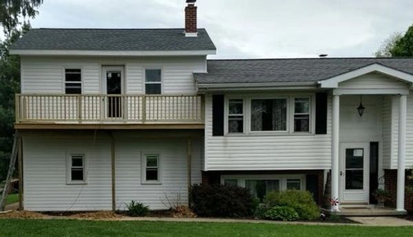 After Thompson & Son's framed and finished a second story to this home with a walkout porch.
