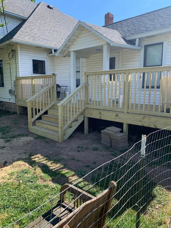 After picture of a brand-new wooden deck. Framed and finished by Thompson and Son's Home Improvement