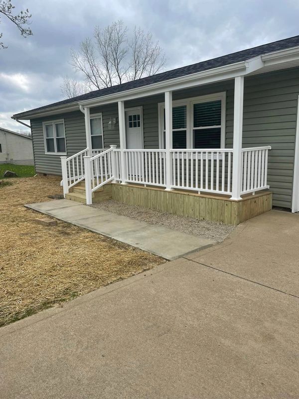 After adding a new concrete sidewalk, new porch, and new siding!