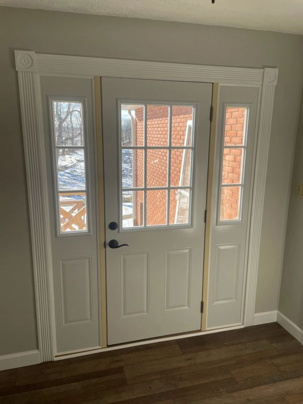 After picture of the new entry door finished with accented trim.