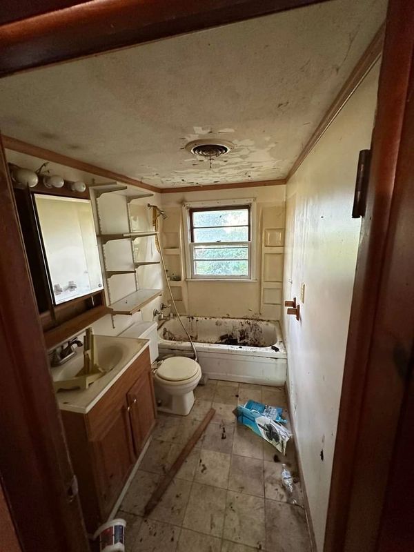 Before picture of the bathroom in our first flip home.