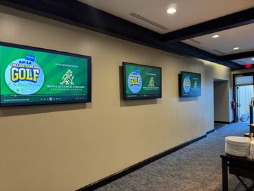 AM&AA Cowboys Golf Tournament Monitors featuring Ironclad Capital Partners sponsorship and logos