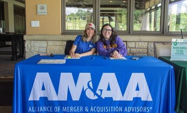 2026 AM&AA Cowboys Golf Tournament check-in table.
