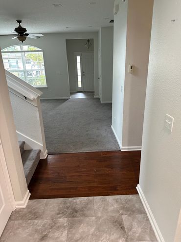 Before picture of busy, multi flooring in house