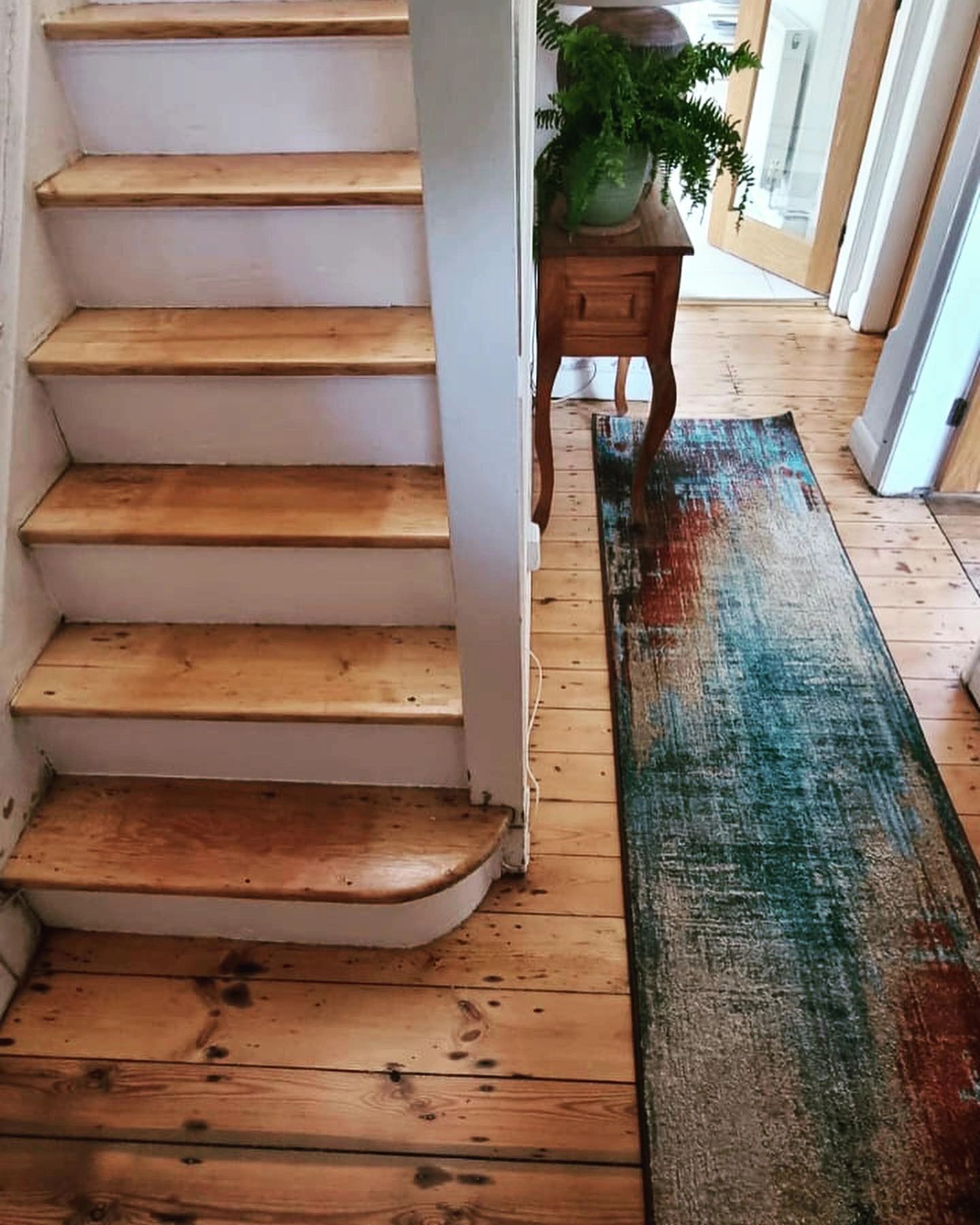Sanded floorboards in a hallway.