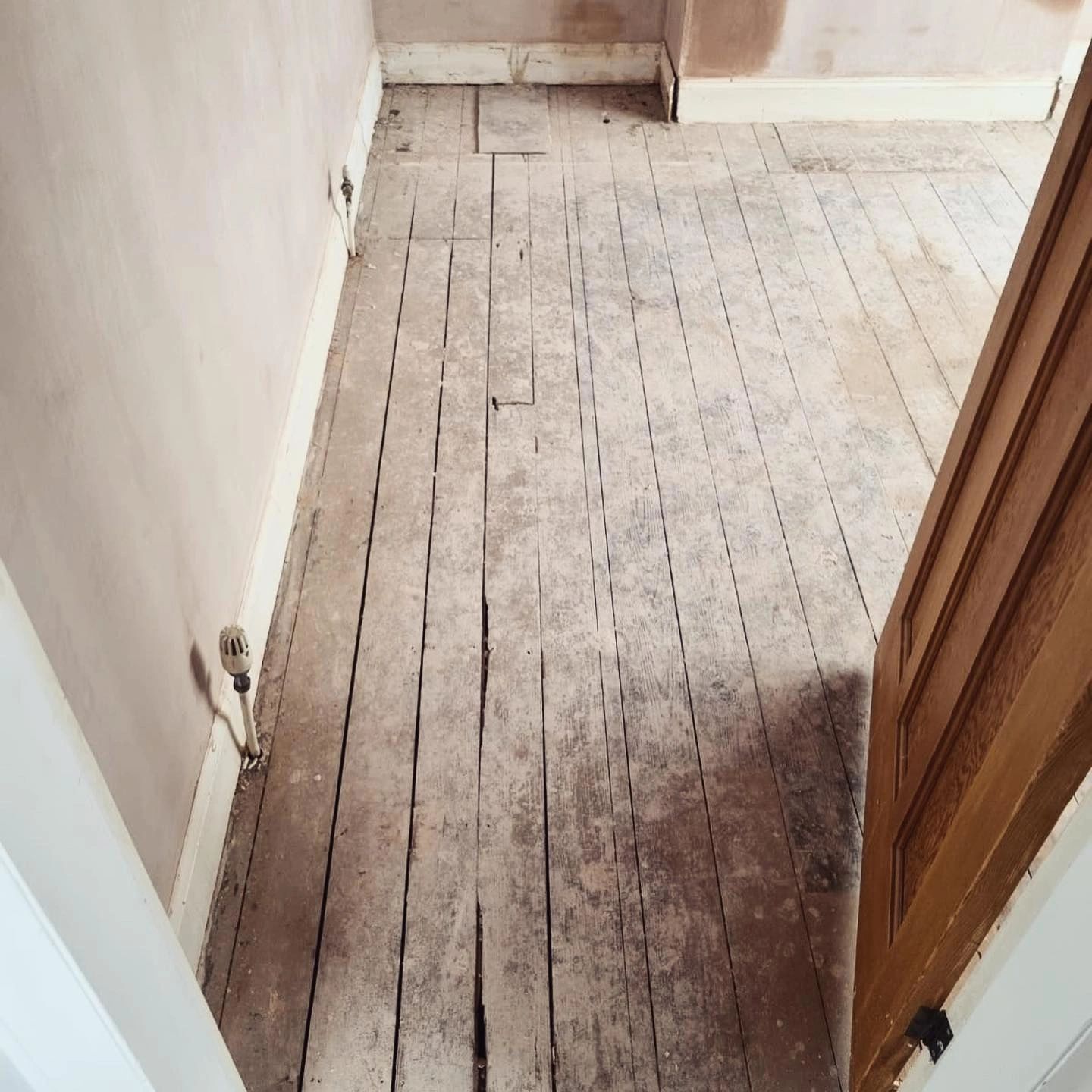 Wooden floorboards before repairs and sanding
