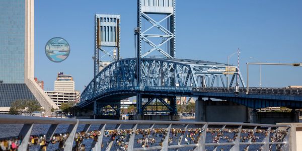 View of Main Street Bridge in Jacksonville, Florida spanning the St. Johns River with city skyline.