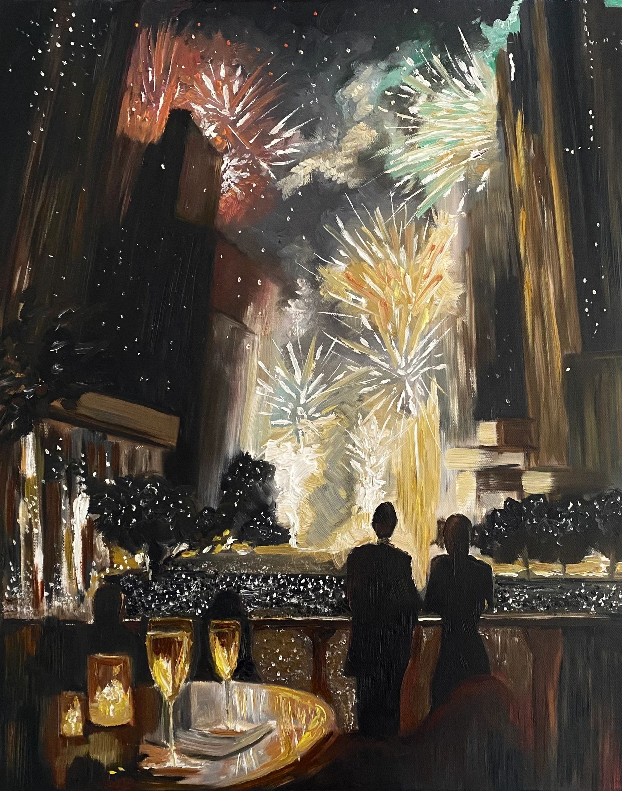 Couple watching fireworks over a cityscape at night, with champagne glasses on a table.