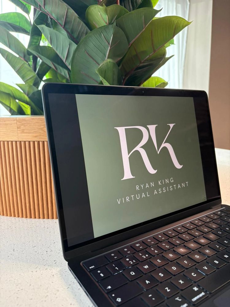 Laptop displaying Ryan King Virtual Assistant logo on green background.
