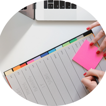 post it on a planner next to a laptop