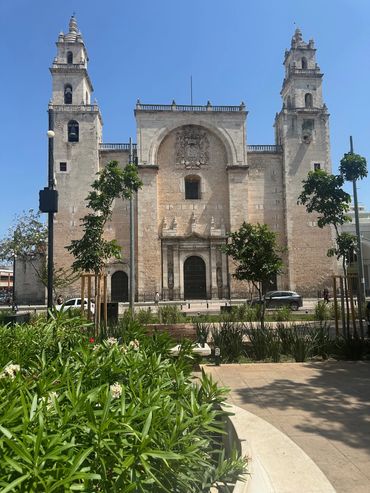 Historic cathedral with twin towers under clear blue sky.