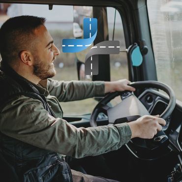 A man happily driving a vehicle with a digital road icon overlay.