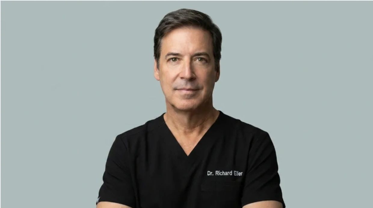 Portrait of a man in black medical scrubs
