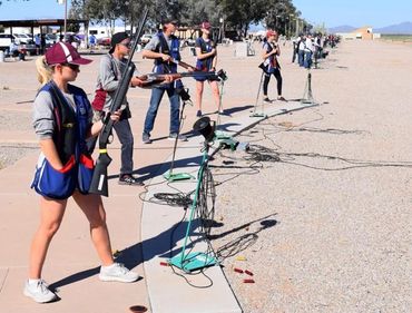 Clay shooting competition with participants lining up outdoors