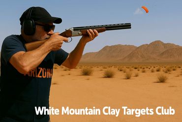 Shooter aiming shotgun at clay target in the desert