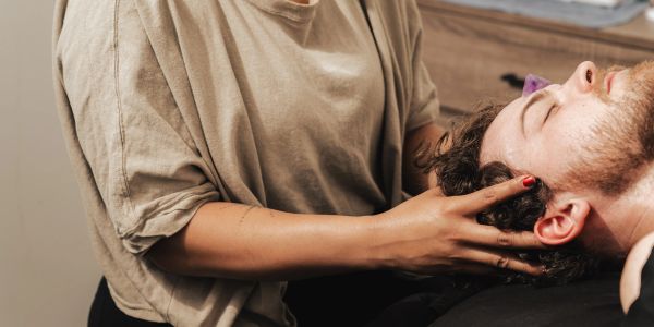 Person receiving a head massage.