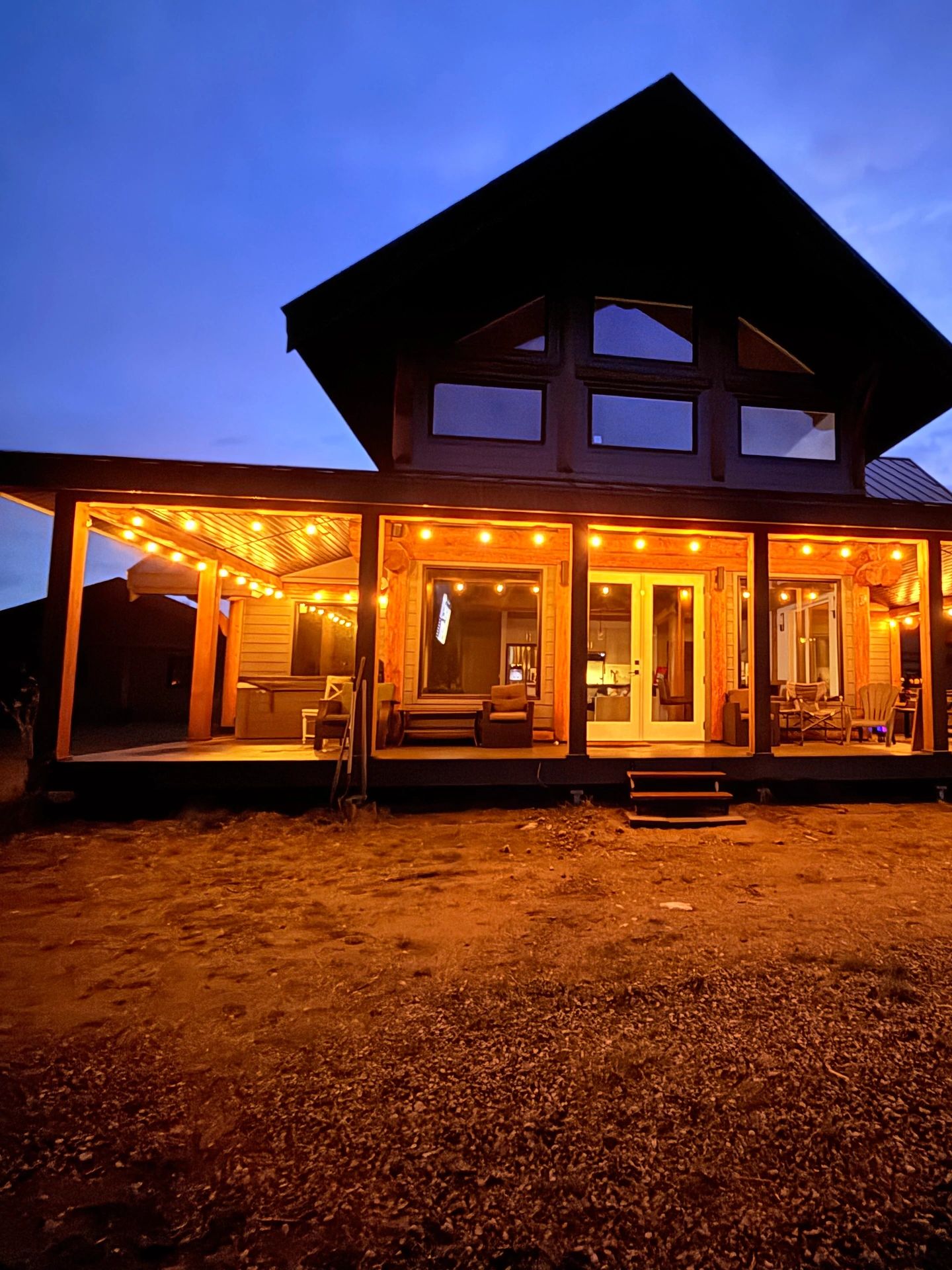 McCulloch Lake Cabins exterior lit up at dusk, a lakefront cabin rental near Kelowna, BC.